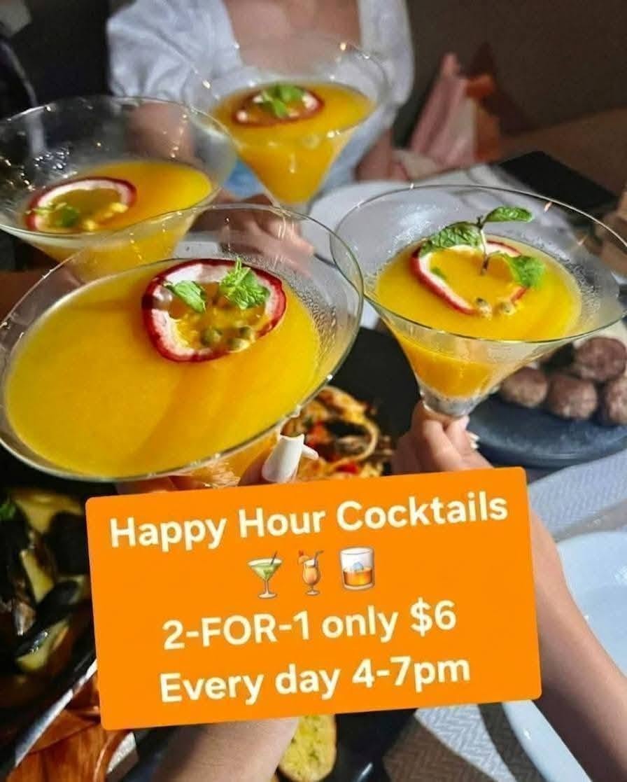 orange cocktails in martini glasses (2-for-1 Happy Hour)